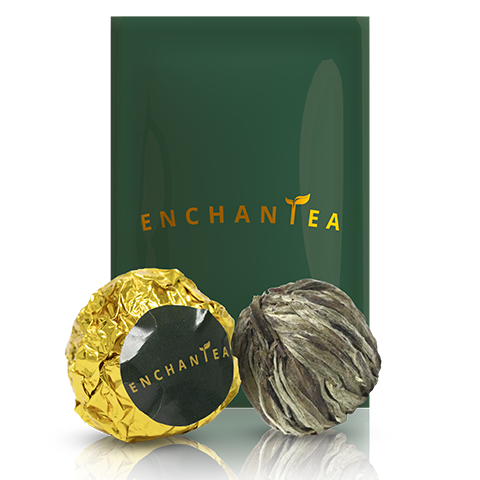 EnchanTea premium tea packaging with handcrafted tea balls on dark background