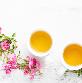 2 tea cups arranged with Flowers by Anverally